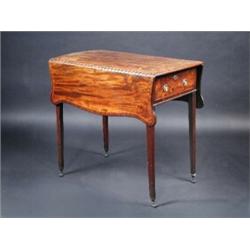 A Regency mahogany butterfly Pembroke table, the shaped line inlaid twin flap top above a deep end..