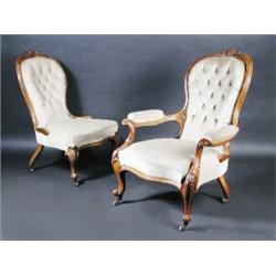 A pair of Victorian walnut framed salon chairs, one with arms, each with carved top rail above a bu.