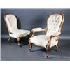 Image 1 : A pair of Victorian walnut framed salon chairs, one with arms, each with carved top rail above a bu.