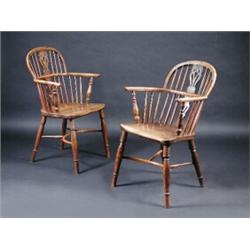 A near pair of 19th century yew wood and elm Windsor chairs, each with bowed top rail above a spind.