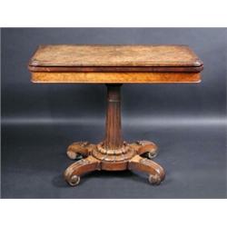 A William IV walnut card table, the moulded rounded rectangular baize lined twin flap top supported.