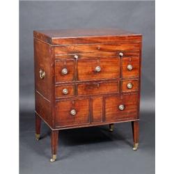 A George III mahogany dressing chest, the square rising top enclosing a fitted interior above a slid