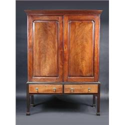 A George III mahogany cupboard on later stand, the upper section with moulded cornice above a pair..