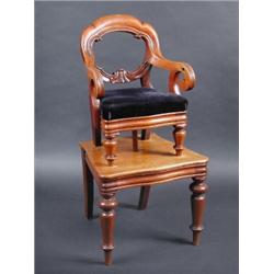 A Victorian mahogany child's high chair, the arched top rail above scrolling arms and drop in seat s