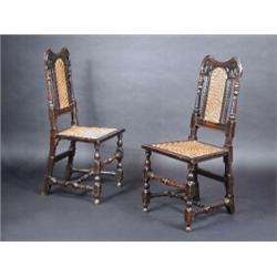 A pair of late 17th century oak side chairs, each with shaped top rail above a caned back and seat f