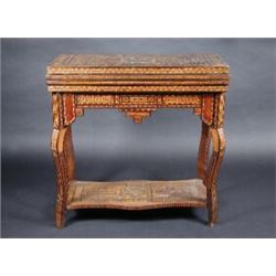 A 19th century parquetry inlaid games table, the profusely inlaid rectangular fold over top enclosi.