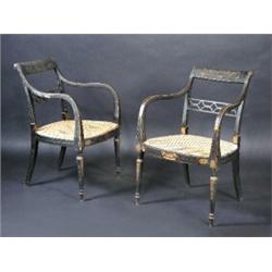 A pair of Regency decorated armchairs, each with scrolling top rail above a pierced rail, downswept.