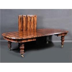 A coromandel and mahogany extending dining table, the moulded rounded rectangular top incorporating.