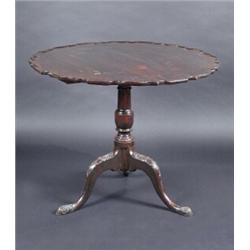 A 19th century stained beech tripod table, the circular tilt top with pie crust edge supported on a.