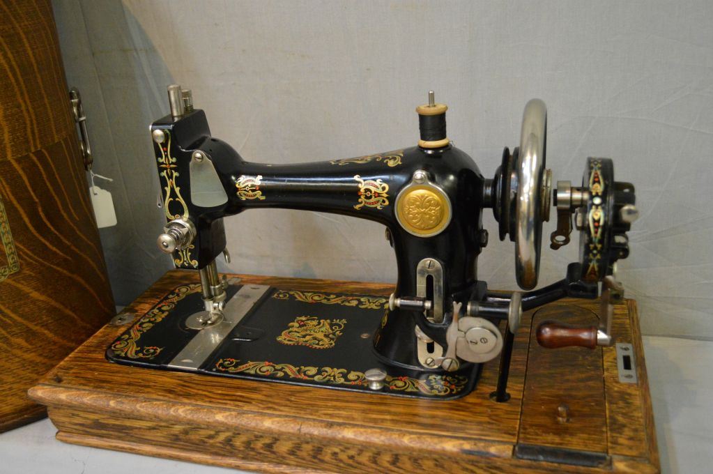 Antique T. Eaton hand crank portable sewing machine with original