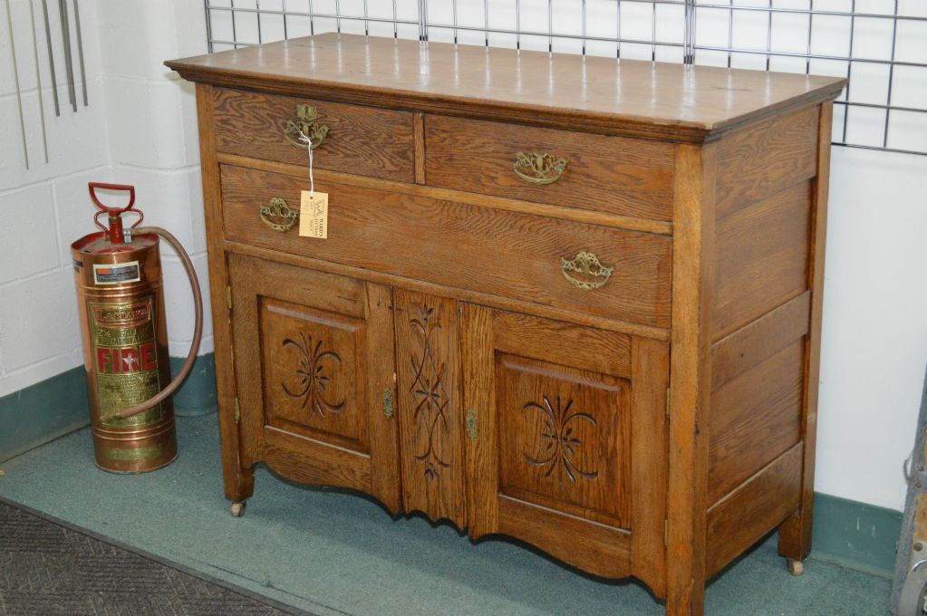 Antique oak three drawer sideboard with two raised panel lower doors 46