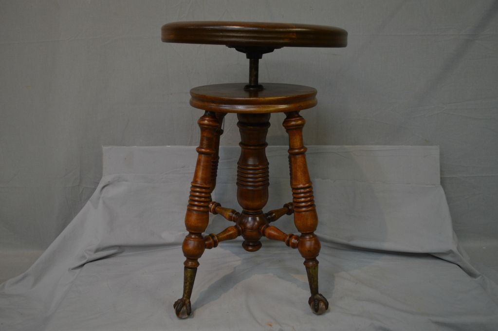 Antique adjustable piano stool with cast and glass ball and claw feet