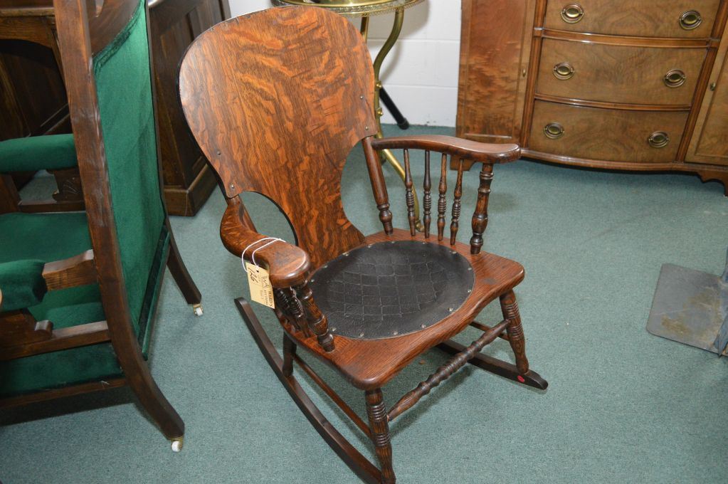 Antique quarter cut oak rocking chair with turned spindle arm supports