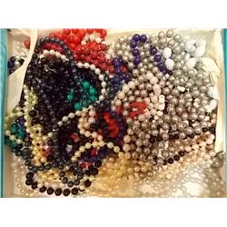 BLUE CASE OF ASSORTED BEADED NECKLACES