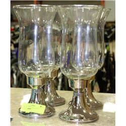 FOUR SILVER PLATED CANDLE HOLDERS