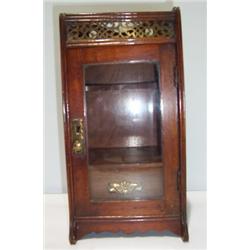 AN EARLY 20th CENTURY OAK SMOKER'S COMPANION, with gallery top, brass fret work and glazed door 40..