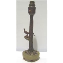 AN INTERESTING COLD CAST PAINTED LAMP BASE, in form of pheasant seated on tree stump. Mounted on ci.