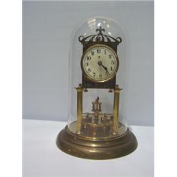 A BRASS SKELETON CLOCK, with glass dome & white dial bearing the initials B and Crescent Moon 60 -..