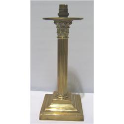 A BRASS CORINTHIAN STYLE CANDLESTICK, converted to electric 50 - 80...