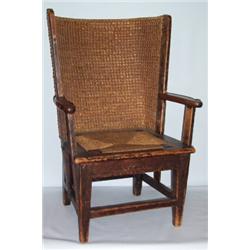 A PINE & WICKER ORKNEY ARMCHAIR, with a wicker back & lifting seat. Circa 19th C. In the manner of..