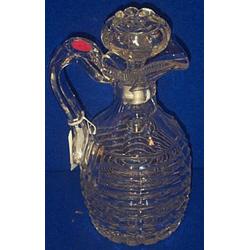 A CUSHION CUT CLARET JUG, c.1840, with faceted shoulders and star cut base, with associated st...