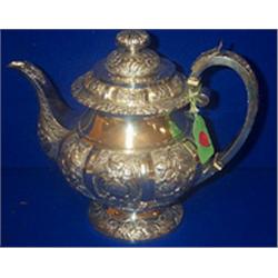 AN EMBOSSED TEAPOT, DUBLIN 1827, Ed. Power, with acanthus finial, the body with panels of styl...