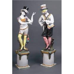 A PAIR OF GLAZED TERRACOTTA COMMODIA del ARTE FIGURES OF COLUMBINE AND HARLEQUIN, CONTINENTAL,...