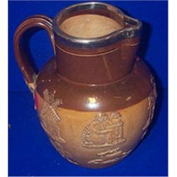 A DOULTON LAMBETH HARVEST JUG, with silver mounts 18cms high. e60/100...