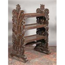 A CARVED STAINED ROSEWOOD DUMB WAITER, 19th CENTURY, PROBABLY INDO-BURMESE, with three galleri...