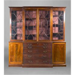 A MAHOGANY BREAKFRONT BOOKCASE, AFTER A CHIPPENDALE PATTERN, with moulded cornice above astrag...