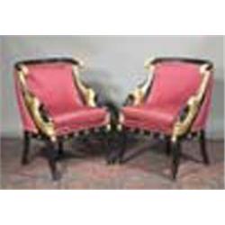 A PAIR OF EBONISED AND PARCEL GILT ARMCHAIRS, IN EMPIRE STYLE, the beaded bowed back rails wit...