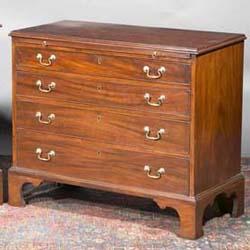 A MAHOGANY CHEST, 18th CENTURY, with moulded rim above a slide, fitted with four graduated lon...