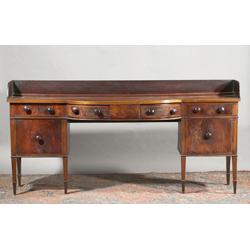 A MAHOGANY BOWED BREAKFRONT SIDEBOARD, IRISH, c.1800, with associated three quarter gallery on...