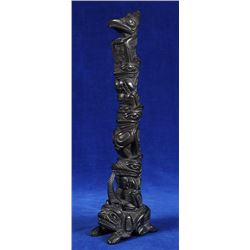 Lionel Samuels Argillite Totem Carved with Thunderbird, Bear, Wasco and Wolf on a Bear Base 11" H.  