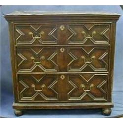 An oak Jacobean chest of 3 long drawers with brass swan neck drop handles raised on bun supports...