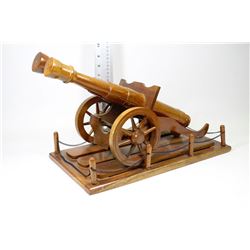 CARVED WOODEN CANNON ON DISPLAY