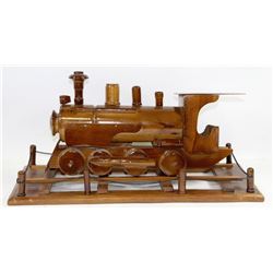 CARVED WOODEN TRAIN ENGINE ON DISPLAY