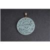 Image 1 : One natural carved jade disc pendant with 14k  yellow gold clasp Est:$150-200