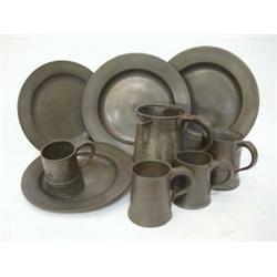 A PAIR OF PEWTER DINNER PLATES, plain bouges, two smaller, a measure and four mugs, all late Geor...
