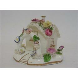 A PASTILLE BURNER, of Coalport type, 19th century, formed as a two storey cottage and garden, hei...