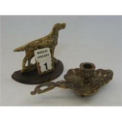AN ART NOUVEAU BRASS CHAMBER CANDLESTICK, and a desk calender with brass dog (2)  20-30...