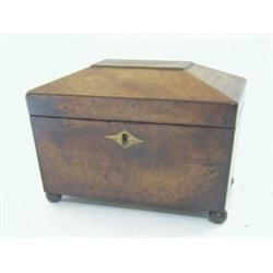 A REGENCY MAHOGANY TEA CADDY, of sarcophagus shape, twin lidded compartments, ball feet, width 20...