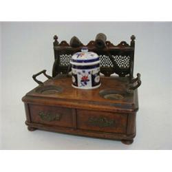 AN EDWARDIAN OAK SMOKERS STAND, gallery back for pipes, tobacco jar and twin frieze drawers, widt...