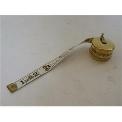 A CIRCULAR BRASS TAPE MEASURE, marked 'Dean'...