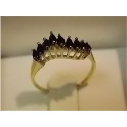RING - 14KT YELLOW GOLD RING - SET WITH 9 MARQUISE FACETTED BLUE SAPPHIRES TOTALLING .7 CW ON WAVE D