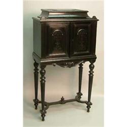 A 19th Century French ebonised collectors cabinet, with box compartment and 2 doors enclosing 5 t...