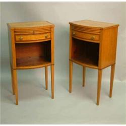 A pair of satinwood bow fronted bedside tables, each with brushing slide and drawer above recess,...