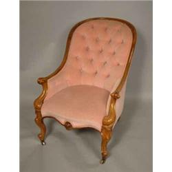 A Victorian walnut buttonback armchair, with pink dralon upholstery and moulded frame, on cabriol...