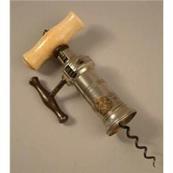 A Kings rack corkscrew with bone handle and silvered barrel applied with a brass coat of arms. (L...