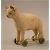 Image 1 : A Steiff white cat toy, with green glass eyes and wooden wheels. height 6.75in....